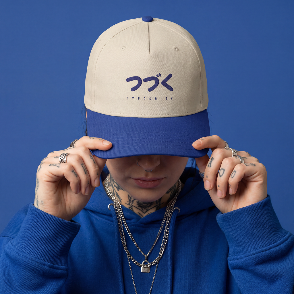Person wearing a beige and blue cap with text on a blue background