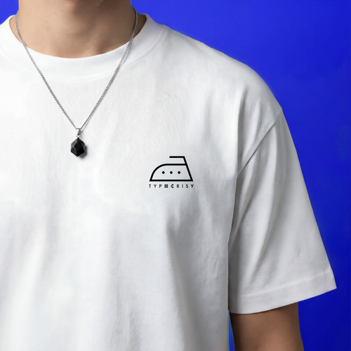 Close-up of white Typocrisy DIRT 25 oversized t-shirt front chest, iron laundry symbol logo with TYPOCRISY wordmark, silver chain necklace with black stone pendant, blue background