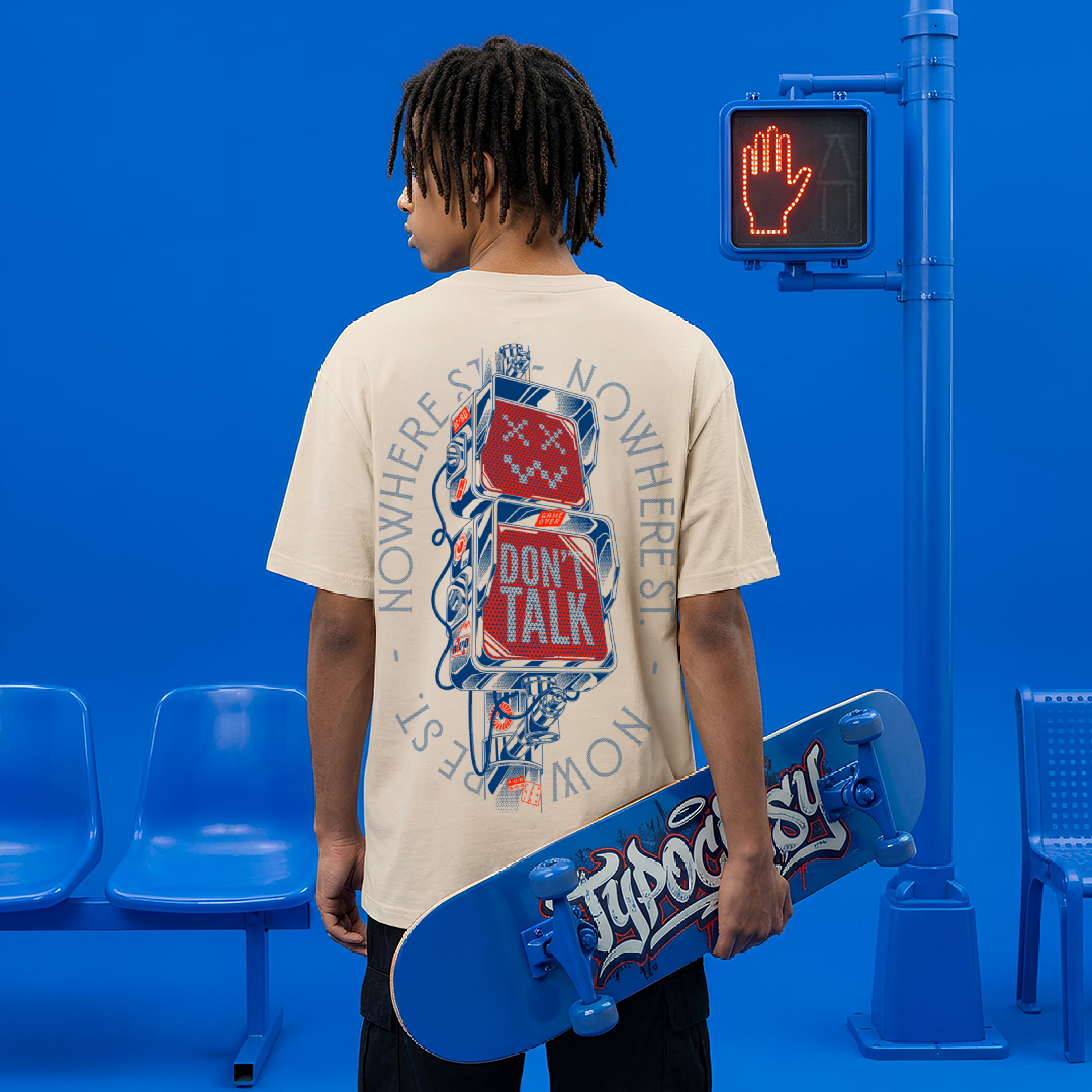 Model wearing beige Typocrisy Don't Talk oversized t-shirt, back graphic with stacked street signs and Nowhere St. circular text