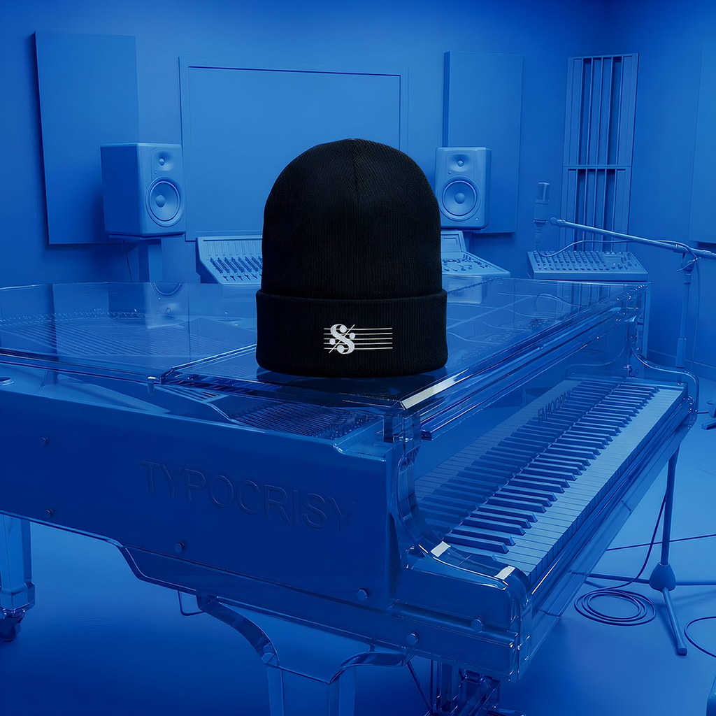 SEGNO Embroidered Black beanie with a logo on a transparent grand piano in a blue-lit room.