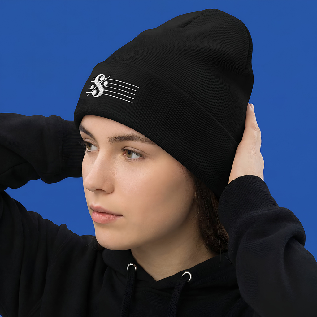Person wearing a SEGNO Embroidered black beanie with a logo against a blue background