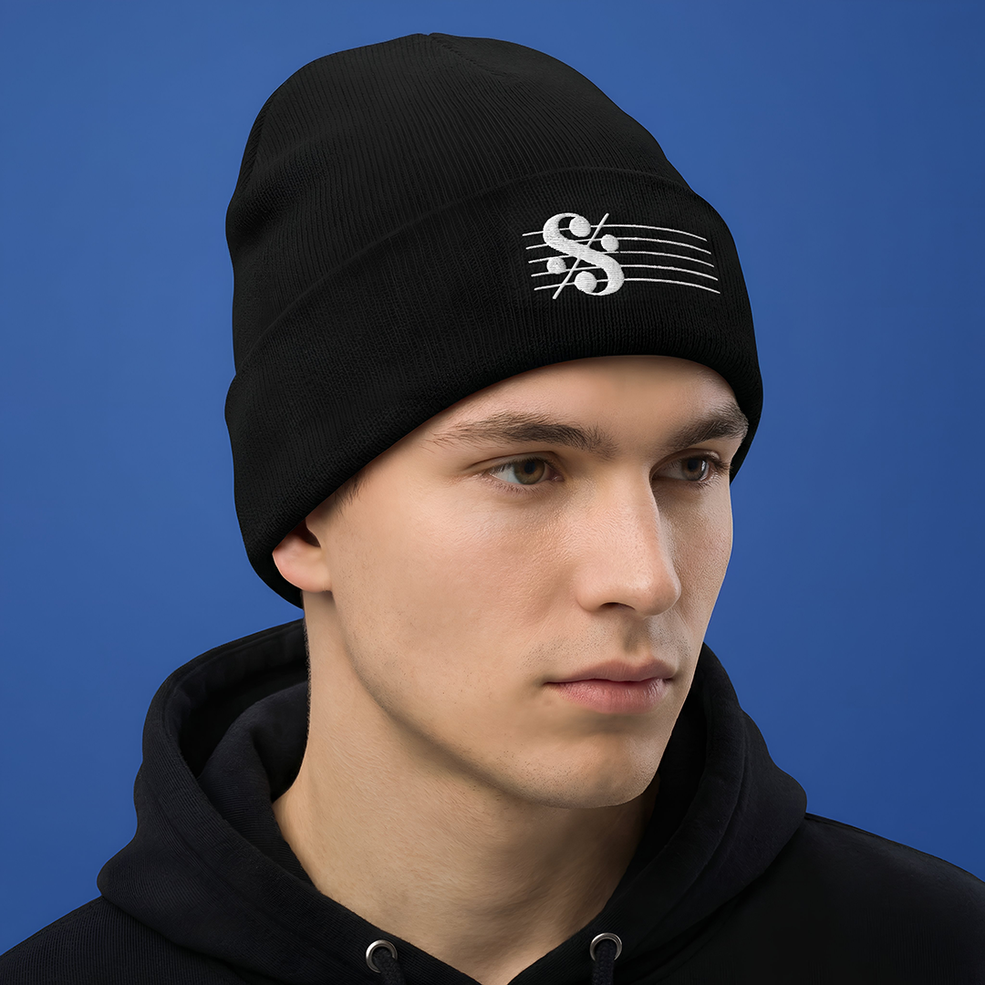 Person wearing a SEGNO Embroidered black beanie with a logo on a blue background