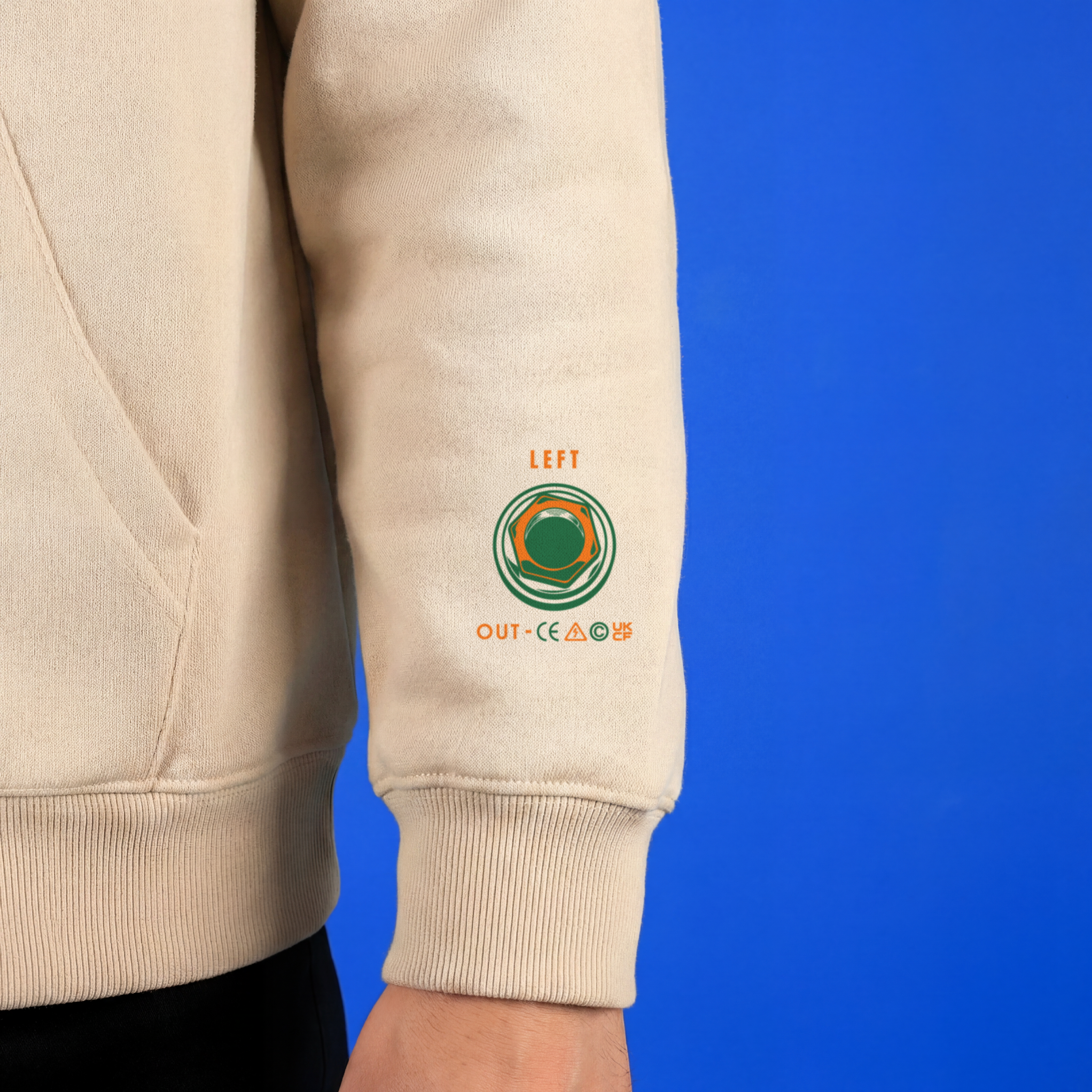 Beige sweatshirt sleeve with a logo and text on a blue background