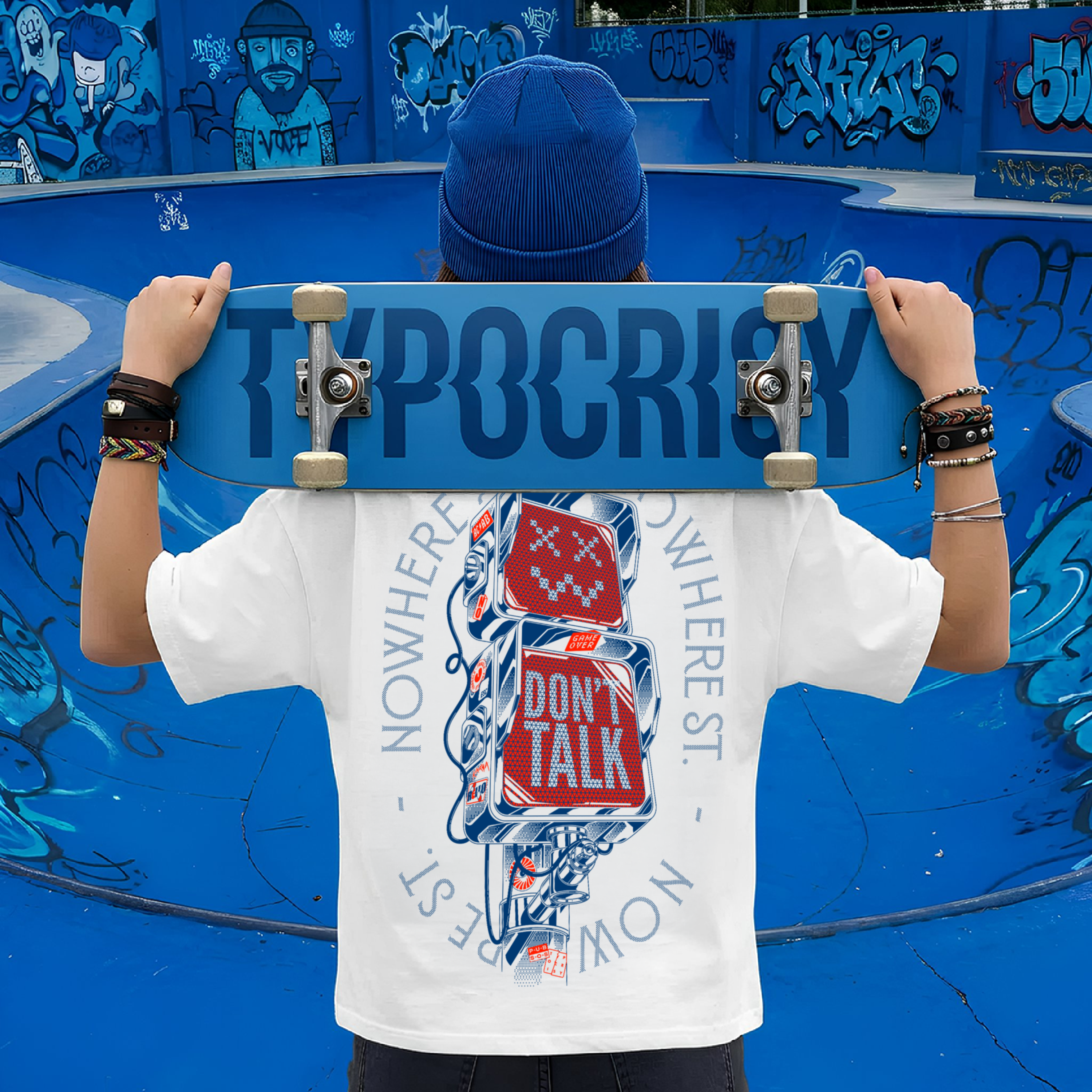 Model at skate park wearing white Typocrisy Dont Talk oversized t-shirt, back graphic, holding Typocrisy skateboard