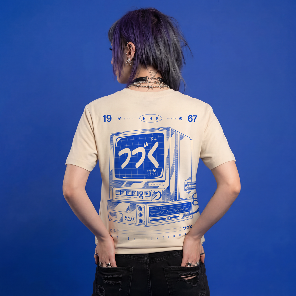 Person wearing a beige t-shirt with a graphic design on the back against a blue background