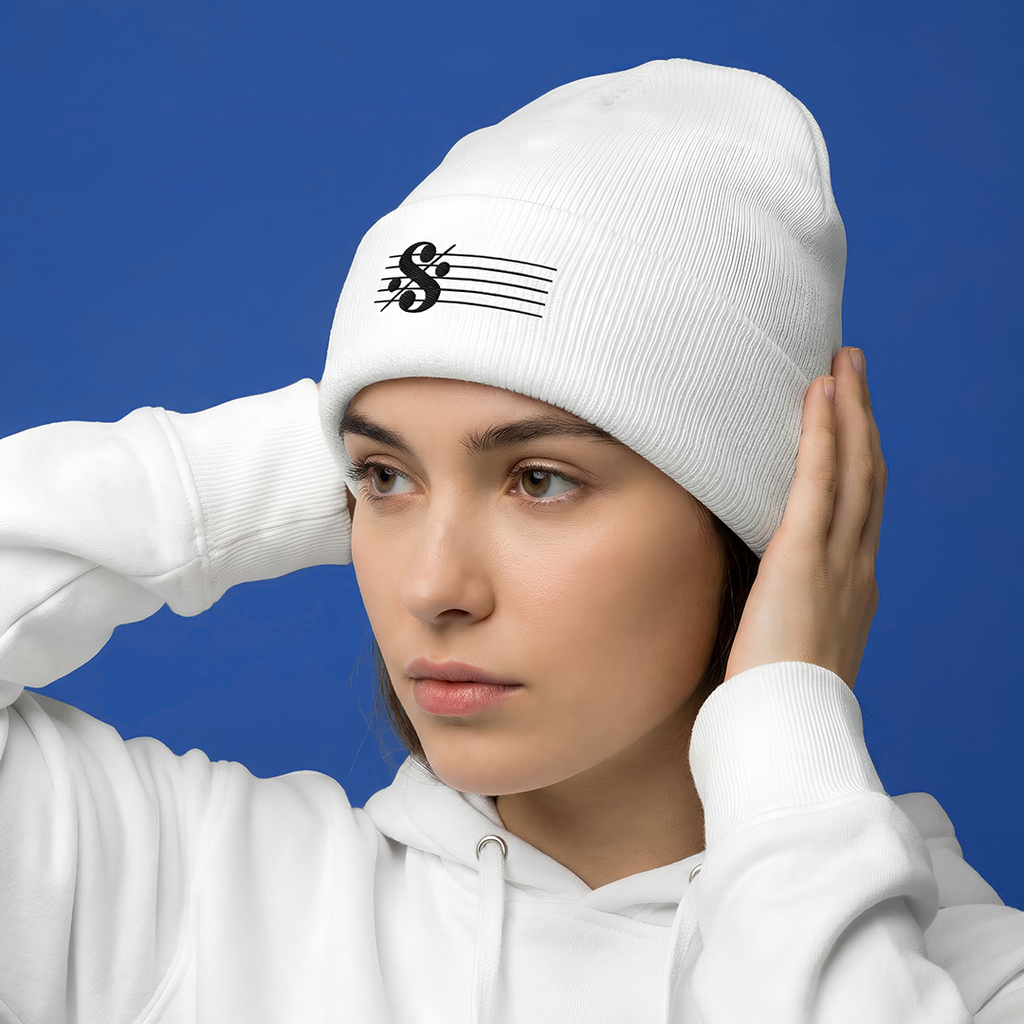Person wearing a Typocrisy SEGNO White Embroidered white beanie with a logo against a blue background