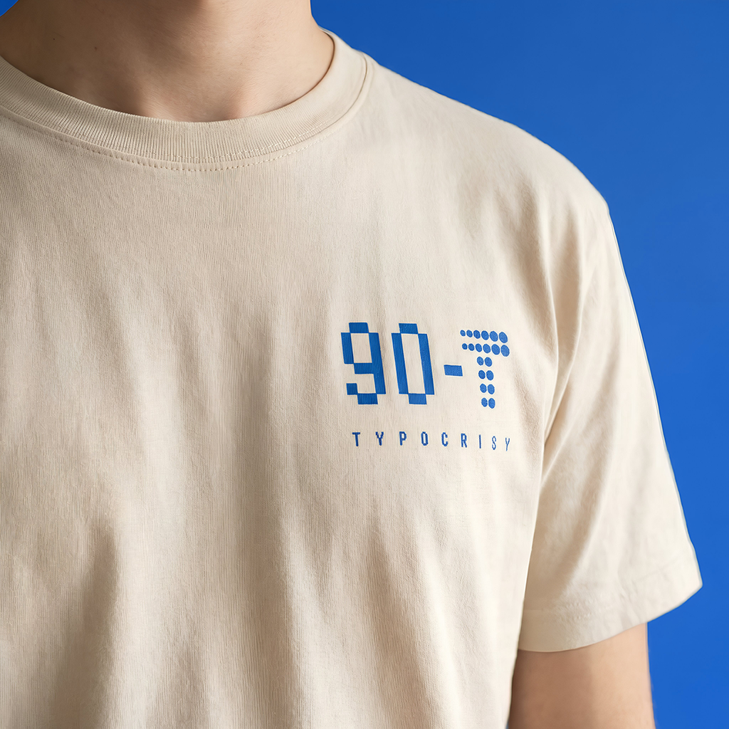 Beige t-shirt with blue and black text design on a blue background