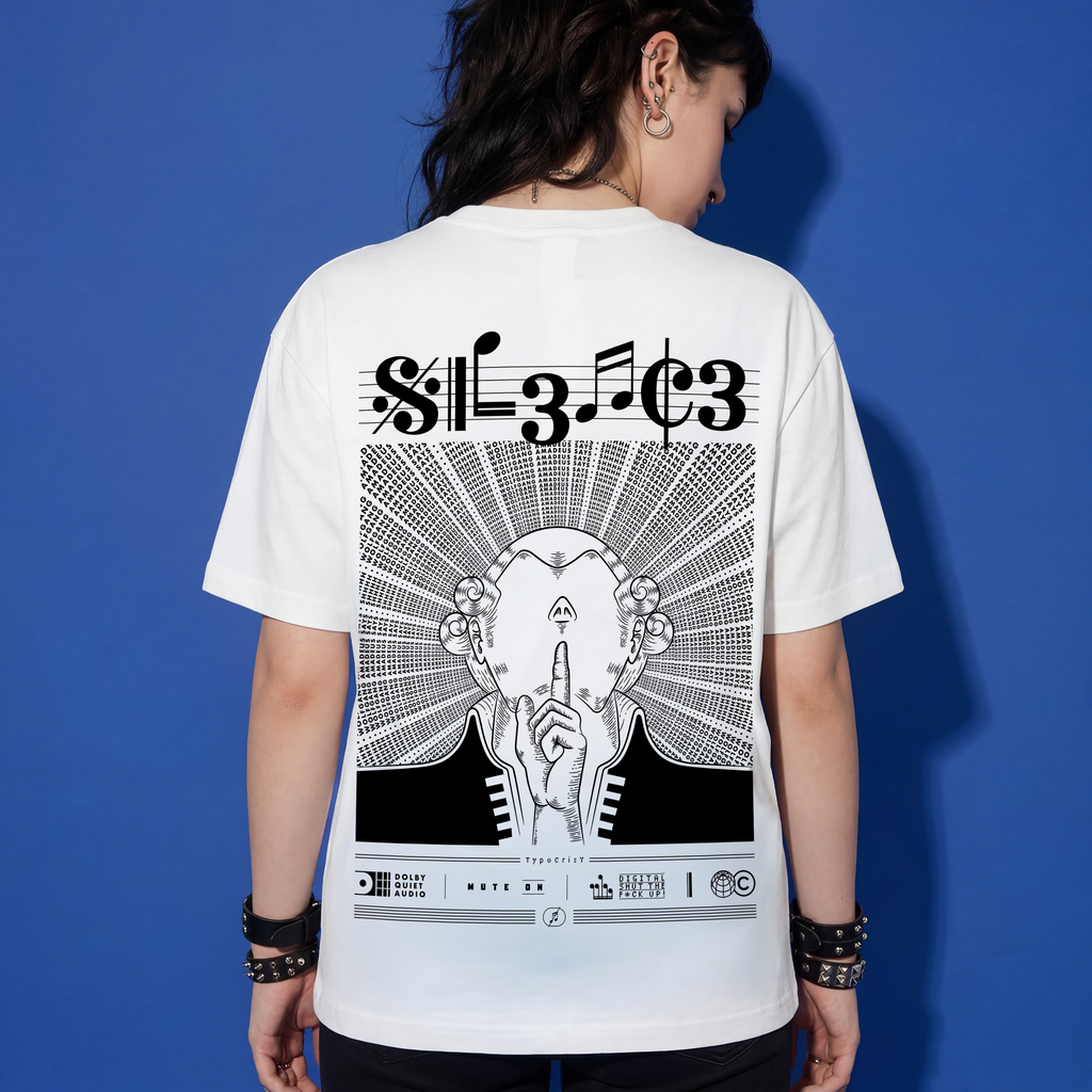 Woman wearing white Typocrisy SIL3NC3 oversized t-shirt, back graphic with SIL3NC3 musical notation title and illustrated silence figure, blue studio background